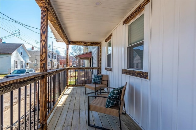 deck with covered porch and a residential view