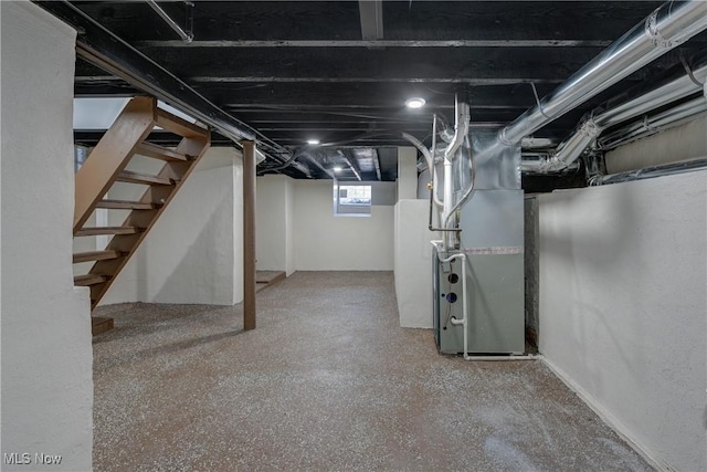 below grade area with heating unit and stairway