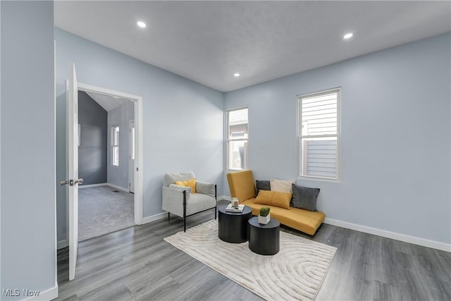 living area featuring recessed lighting, wood finished floors, and baseboards