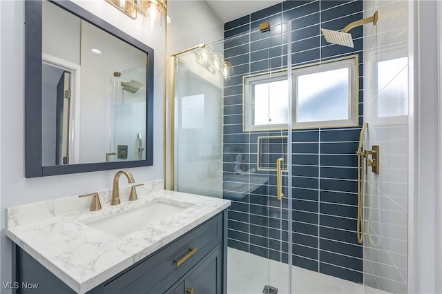 full bath featuring vanity and a stall shower