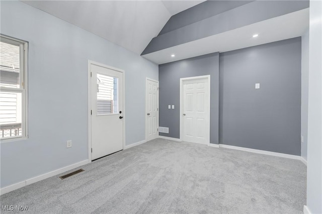 carpeted empty room featuring visible vents, recessed lighting, baseboards, and lofted ceiling