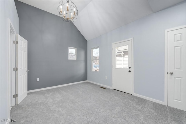 unfurnished room featuring visible vents, baseboards, carpet, a chandelier, and high vaulted ceiling