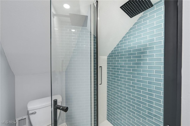 full bath featuring a stall shower, toilet, and lofted ceiling