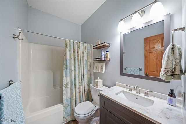 full bathroom featuring shower / bath combo with shower curtain, toilet, and vanity