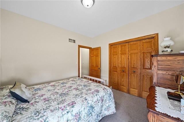 bedroom with a closet, visible vents, and carpet flooring