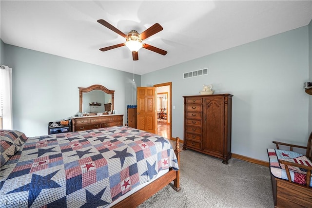 bedroom featuring visible vents, light carpet, baseboards, and ceiling fan