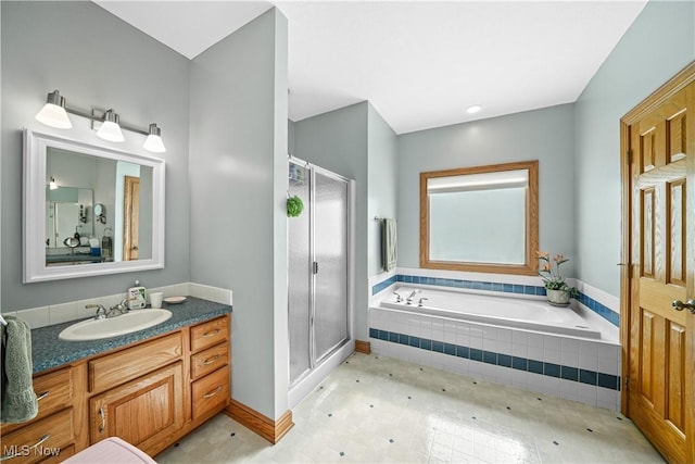 bathroom with vanity, a garden tub, and a stall shower