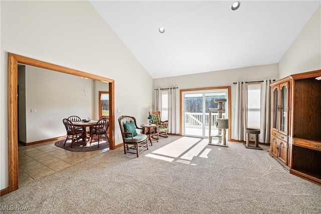 sitting room featuring tile patterned floors, carpet flooring, high vaulted ceiling, and baseboards