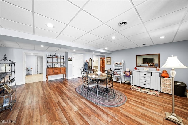 dining space featuring recessed lighting, visible vents, a paneled ceiling, and wood finished floors