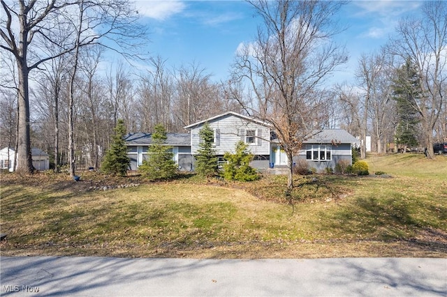 tri-level home with a front lawn