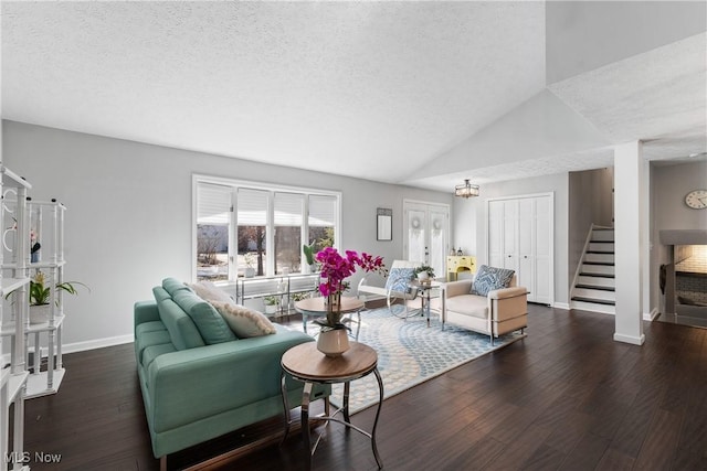 1785 Ashley Dr, Hudson, OH 44236 - living area featuring stairs, baseboards, a textured ceiling, wood finished floors, and vaulted ceiling