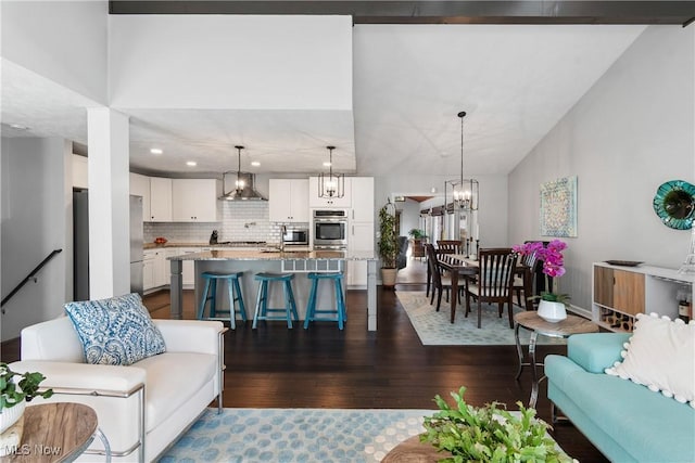 living area featuring recessed lighting, a notable chandelier, and dark wood-style flooring