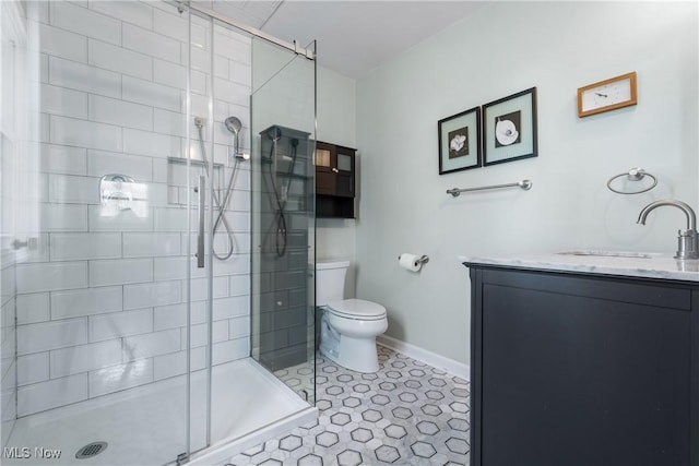 full bath featuring baseboards, toilet, a stall shower, tile patterned floors, and vanity