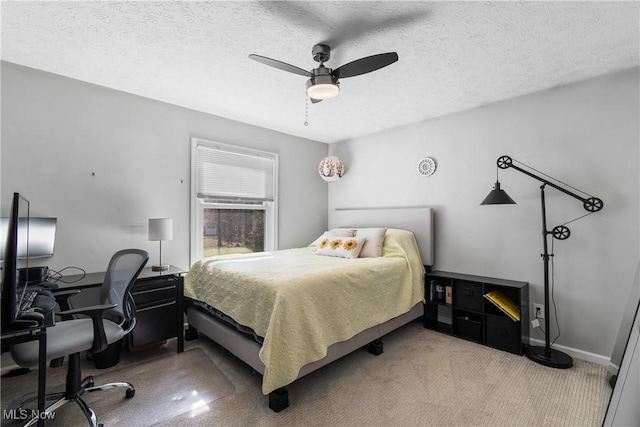 bedroom with ceiling fan, baseboards, and a textured ceiling