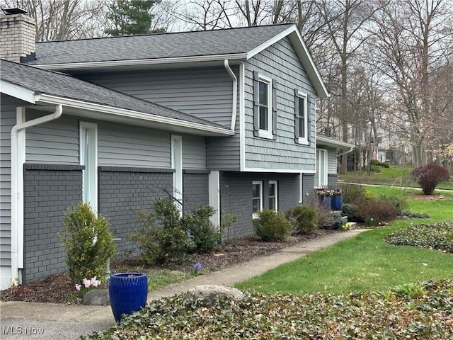 1785 Ashley Dr, Hudson, OH 44236 - view of property exterior with a shingled roof, a chimney, and brick siding