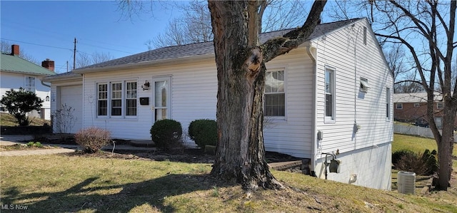 view of front of home with cooling unit and a front lawn