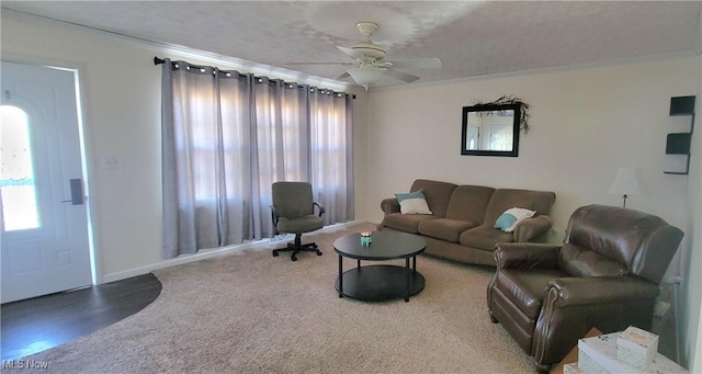 living area featuring ceiling fan and crown molding