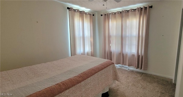 carpeted bedroom featuring visible vents, a textured ceiling, and a ceiling fan