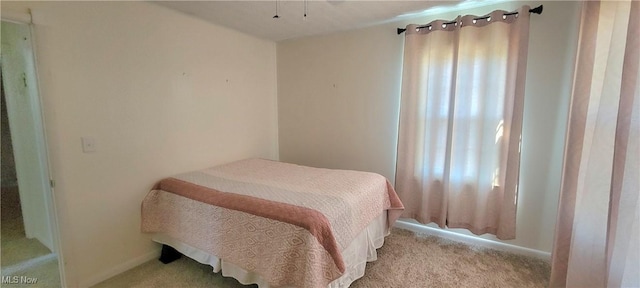 bedroom with baseboards and carpet floors