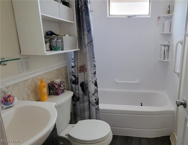 full bathroom featuring a sink, toilet, and shower / tub combo