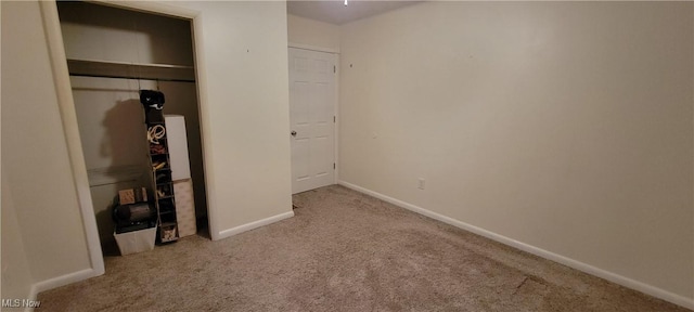 unfurnished bedroom featuring a closet, baseboards, and carpet