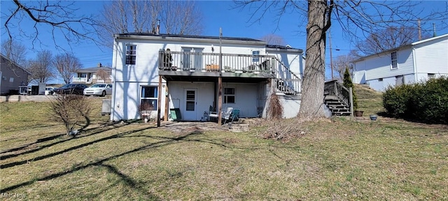 rear view of property with a wooden deck, a lawn, and stairs