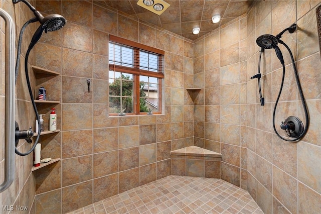 full bath with tiled shower