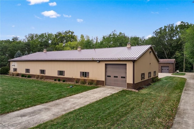 view of side of property with brick siding, a chimney, metal roof, a yard, and a standing seam roof