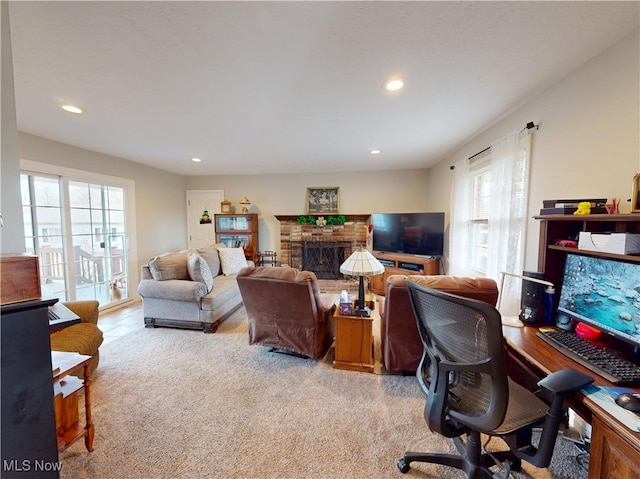 office area featuring carpet flooring, recessed lighting, and a fireplace