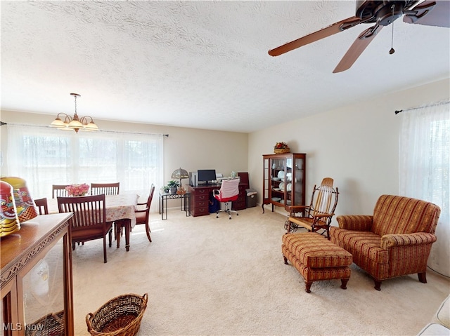 living room with plenty of natural light, light colored carpet, and a textured ceiling