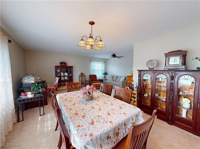 dining room featuring an inviting chandelier and light carpet