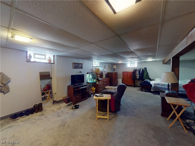 carpeted living room with a drop ceiling