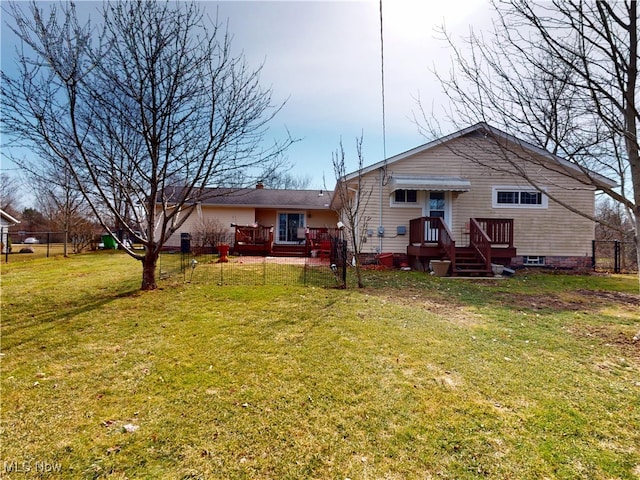 back of house featuring a yard and fence