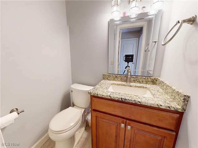 bathroom with toilet and vanity