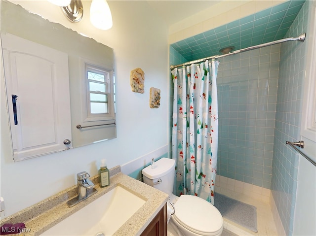 full bath with a shower stall, vanity, and toilet