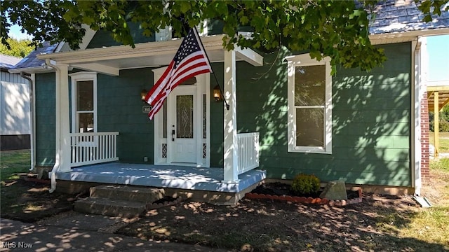 view of exterior entry with a porch