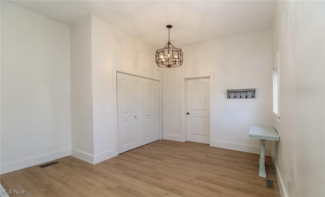 1640 Main St, Stockport, OH 43787 - foyer entrance with light wood-style flooring, a chandelier, and baseboards