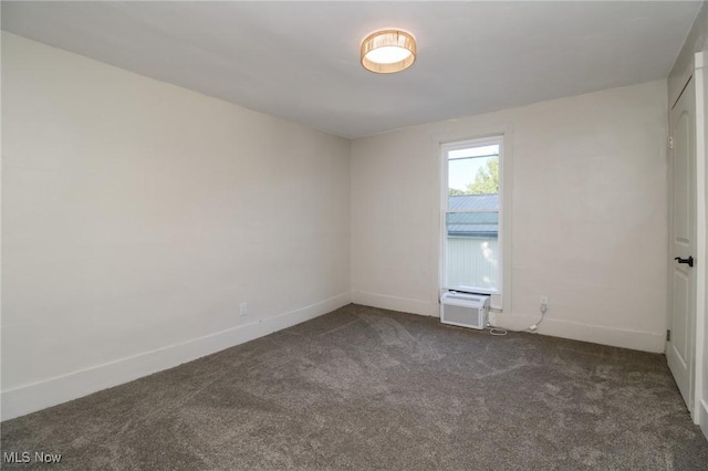 spare room with baseboards, dark carpet, and a wall unit AC