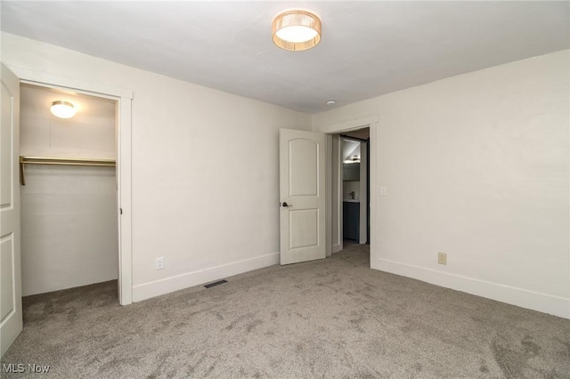 unfurnished bedroom with baseboards, visible vents, and carpet floors