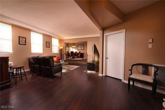 living room featuring baseboards and dark wood finished floors