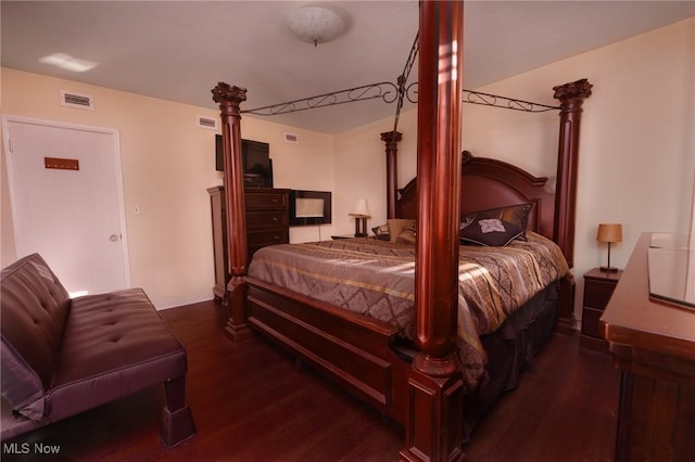 bedroom with wood finished floors and visible vents