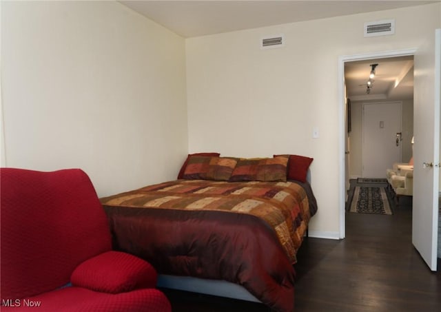 bedroom with wood finished floors and visible vents