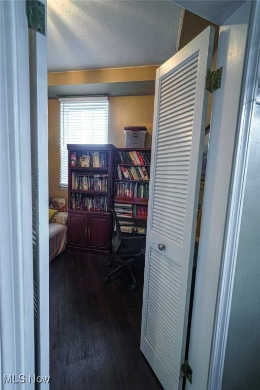 bedroom with dark wood-style floors and a textured ceiling