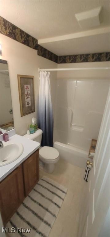 full bath featuring toilet, vanity, and shower / bath combination with curtain