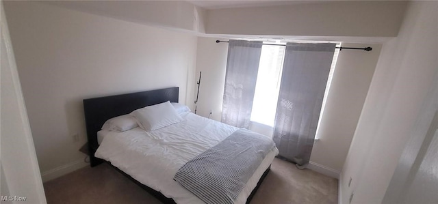 carpeted bedroom featuring baseboards