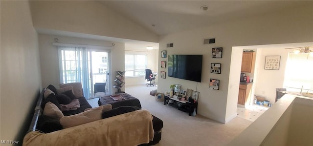 living room with visible vents, light colored carpet, and lofted ceiling