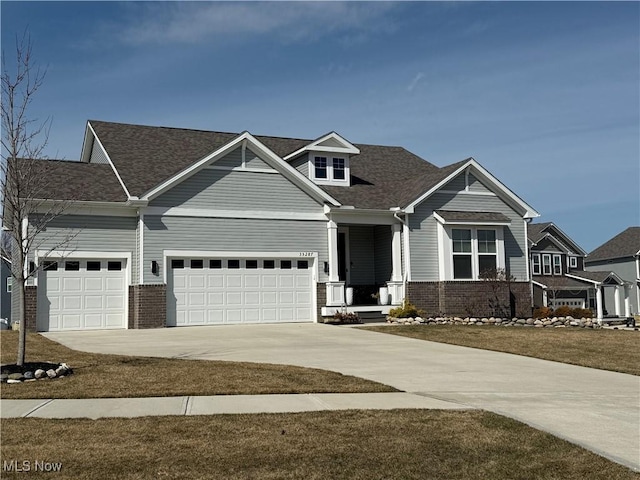 craftsman inspired home with brick siding, driveway, and an attached garage