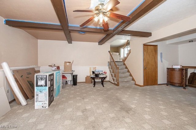 below grade area featuring stairway, a ceiling fan, and carpet flooring