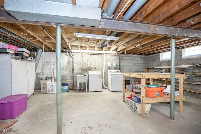 below grade area featuring a sink and separate washer and dryer