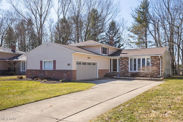 view of front of home featuring a garage, driveway, brick siding, and a front lawn